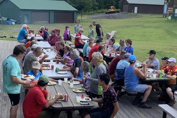 outdoor diners at multiple picnic tables