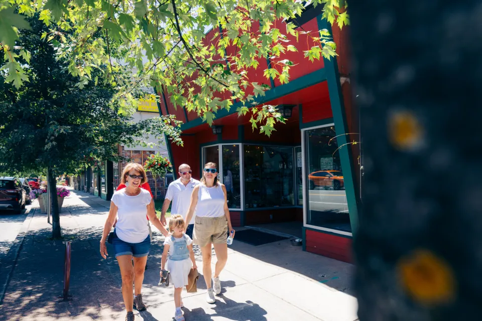 A family walks in a downtown of a small town.