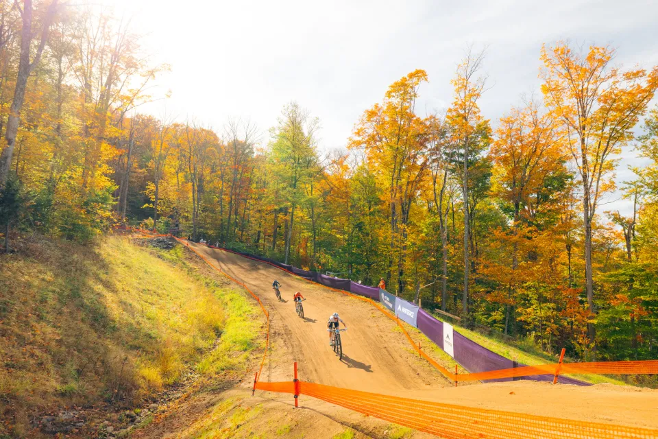 A group of mountain bikers riding down a trail.