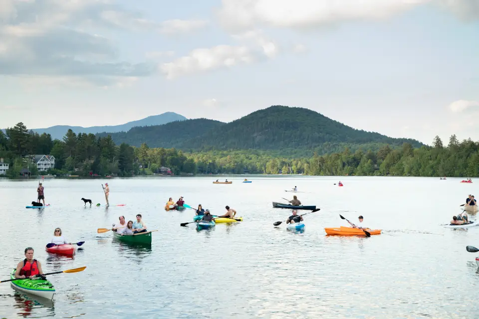 A group of paddlers on Mirror Lake for Lake Placid's summer concert series.