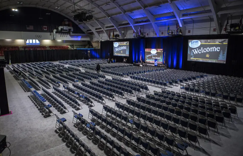 A large arena filled with chairs for a presentation.