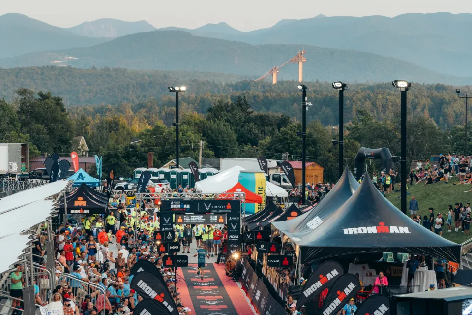 The finish line to an IRONMAN race with mountains in the background. 