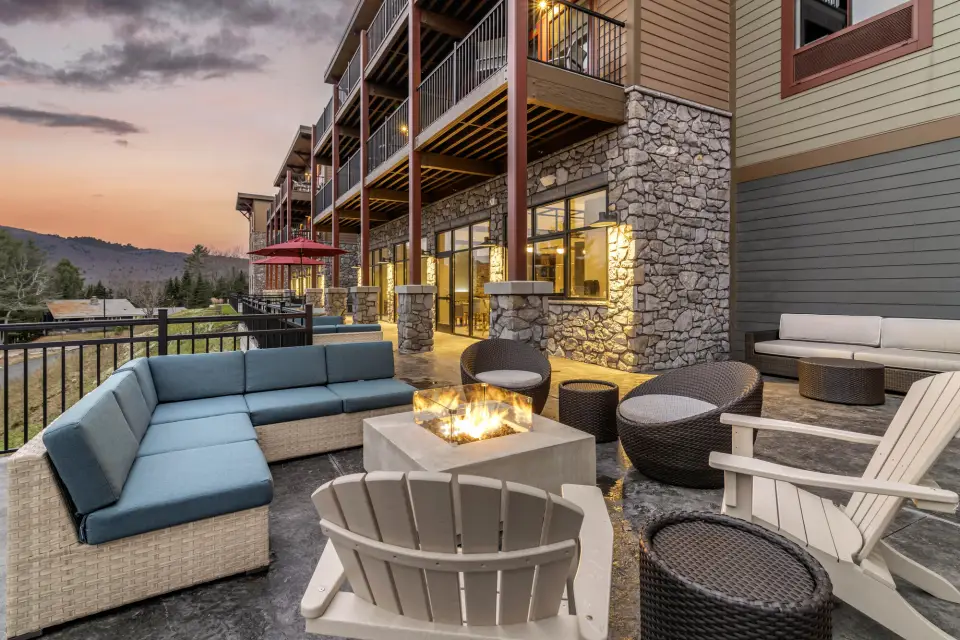 Outside seating area and fire pit at Cambria Hotel at sunset