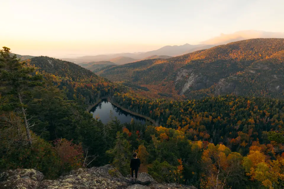 A hiker overlooking Giant's Washbowl, a high elevation pond