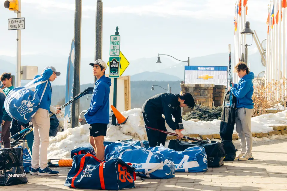 A hockey team prepares on a driveway.