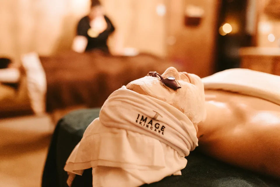 A woman laying down in a spa getting a facial.