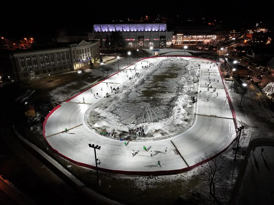 Aerial view of Lake Placid's speed skating oval transformed into multiple ice hockey rinks.
