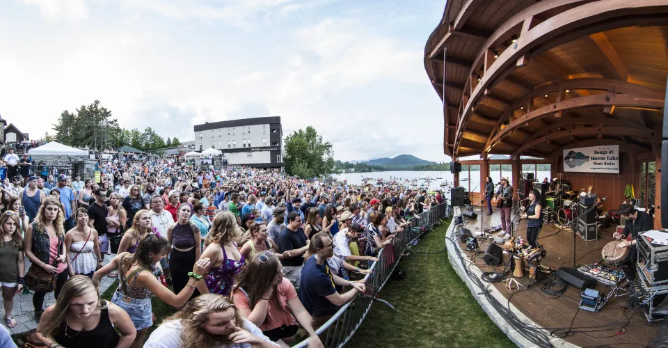 A crowd of people watching live music in Lake Placid.