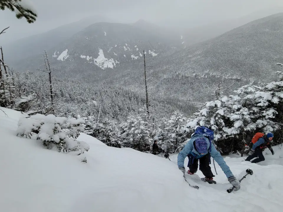 A winter hiker going up a steep slope