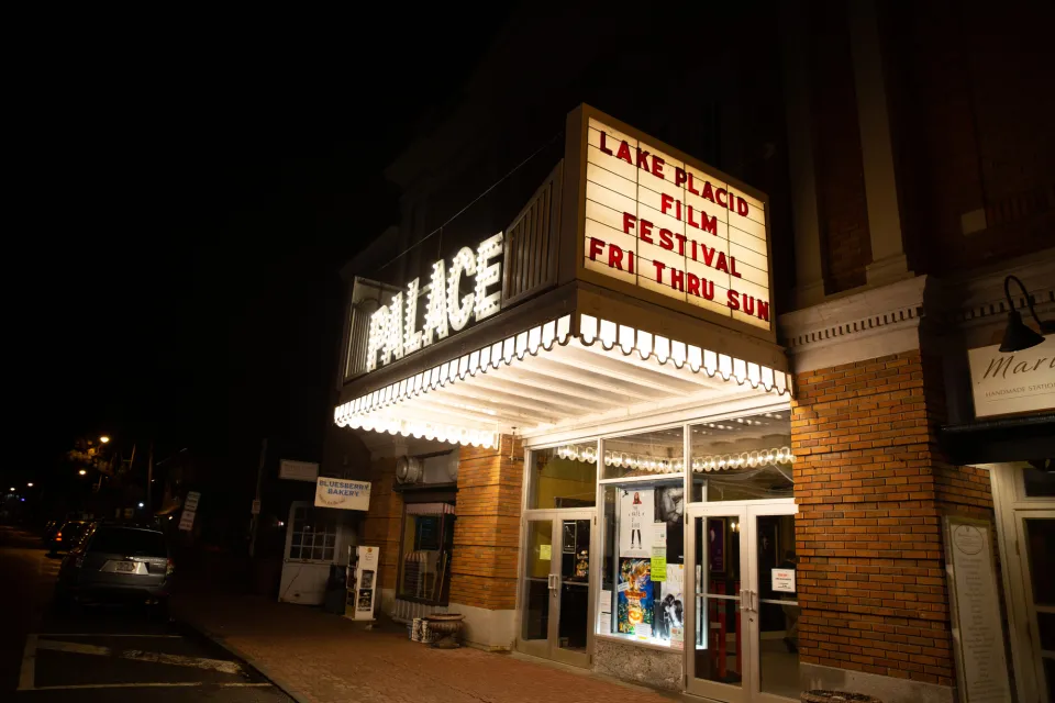 The lit marquee of a classic movie house during a film festival.