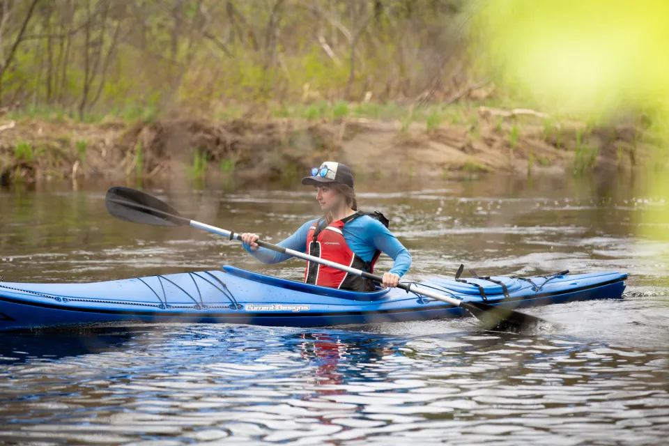 A kayaker on the water during the spring.