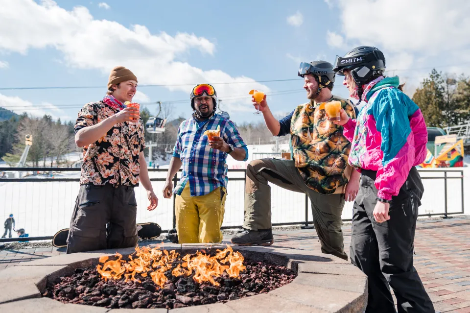 A group of spring skiers drinking beer on the Whiteface deck.
