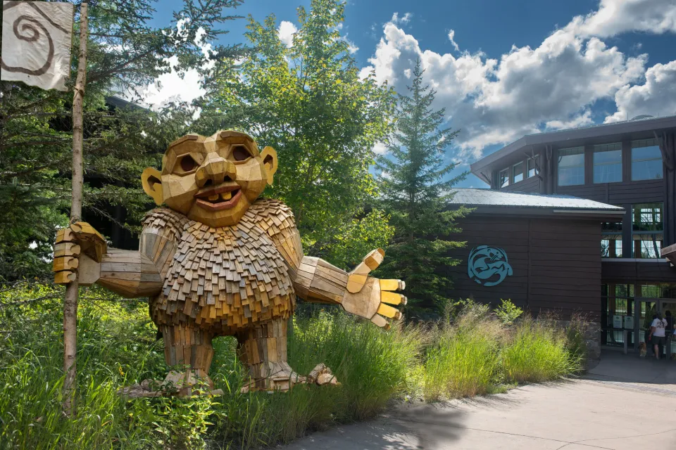 A troll stands in front of a science museum.