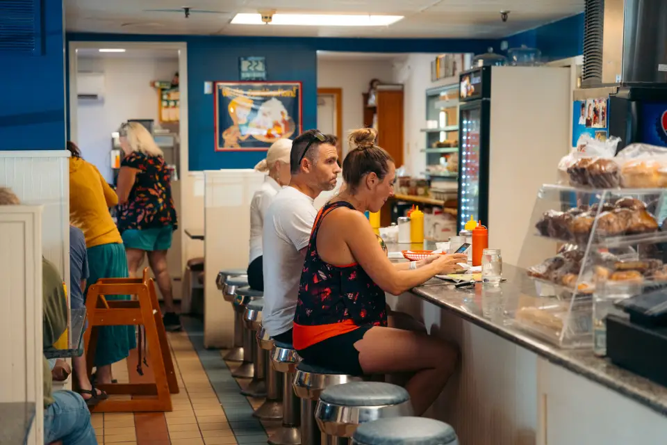People eating at the counter of Noonmark Diner