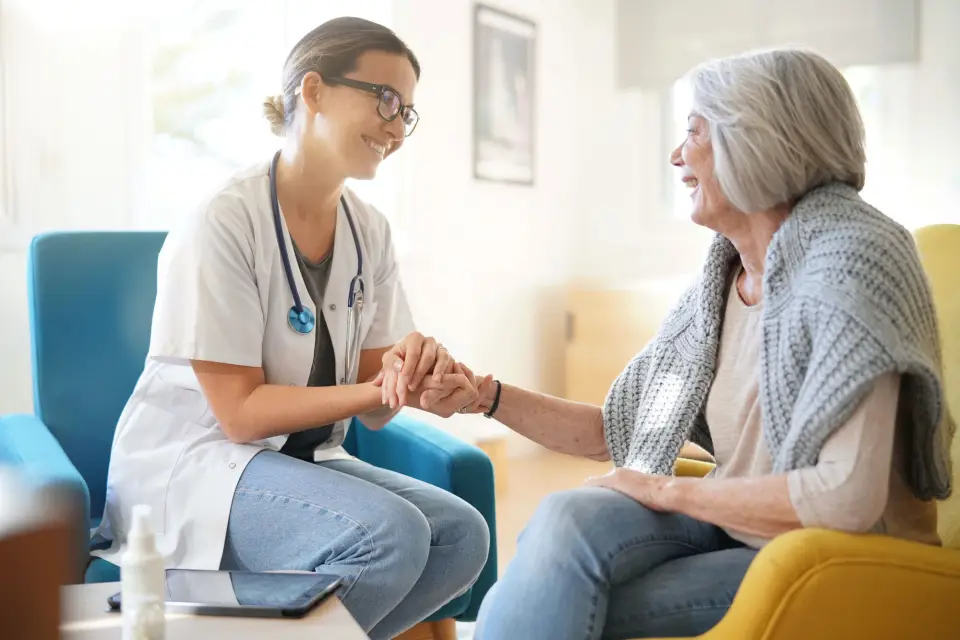 An older woman talks with her doctor about treatment.