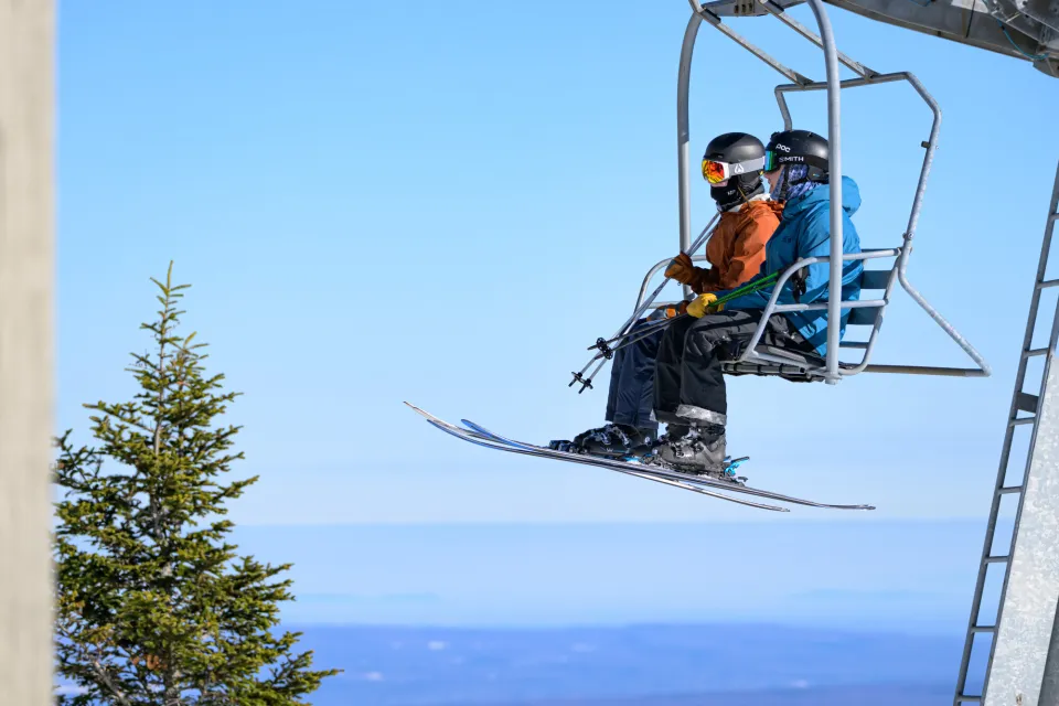 Skiers on a chairlift