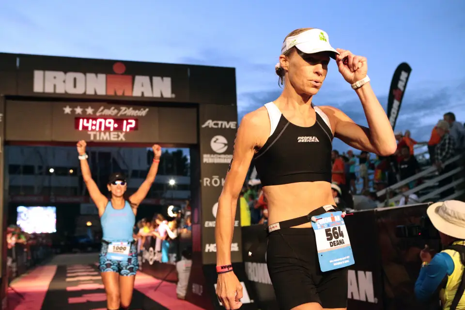 A woman walks off after finishing an Ironman race.
