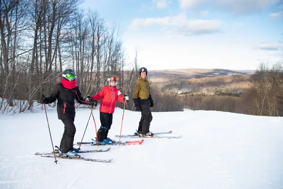 A family skiing at Titus Mountain.