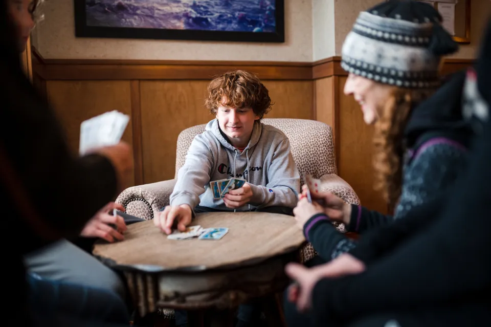 A family plays cards together. 