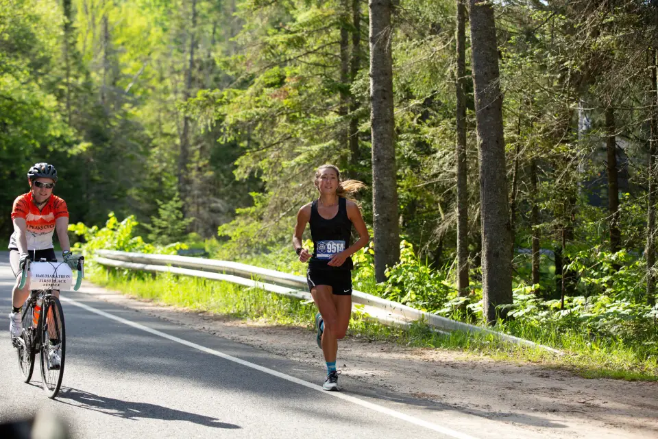 A woman runs on a spring road.