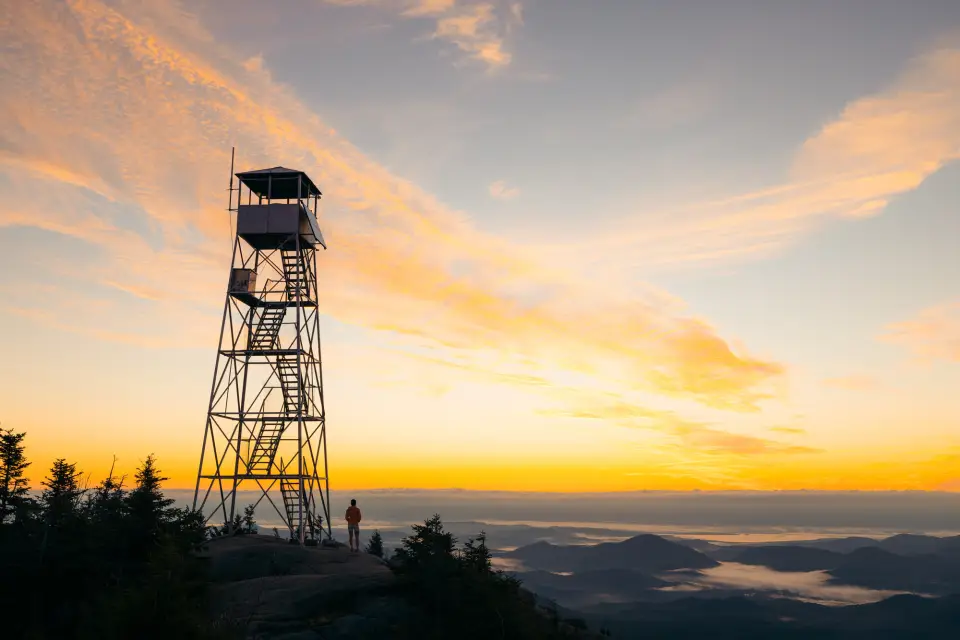 A firetower's silhouette at sunrise