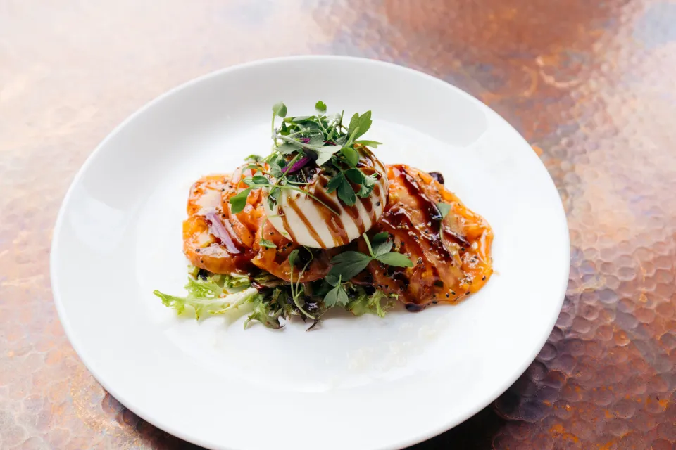 A close-up of a plate of fine dining food on a clean white plate.