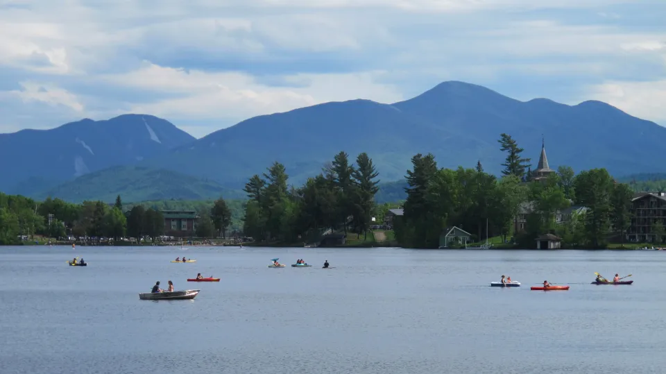 A variety of boats on Mirror Lake in Lake Placid during the summer.