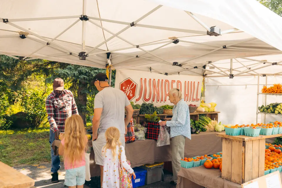 A family buying vegetables at a farmers market