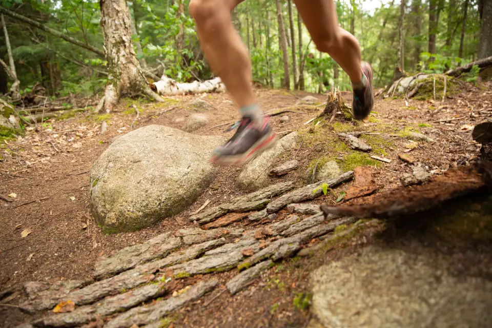 A person running on a trail.