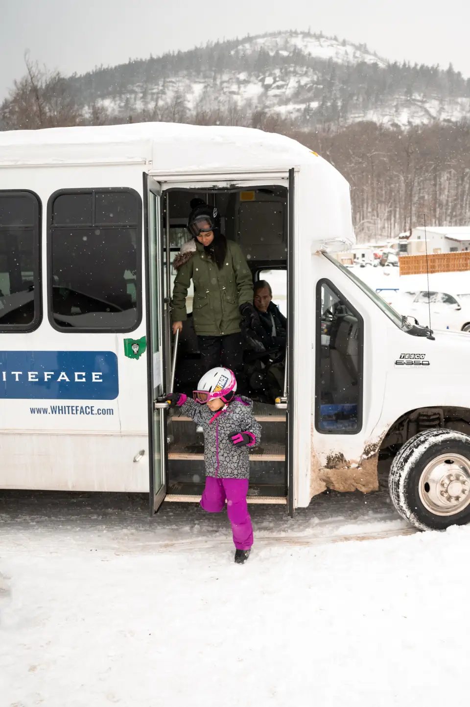 People unloading from a Whiteface shuttle bus.