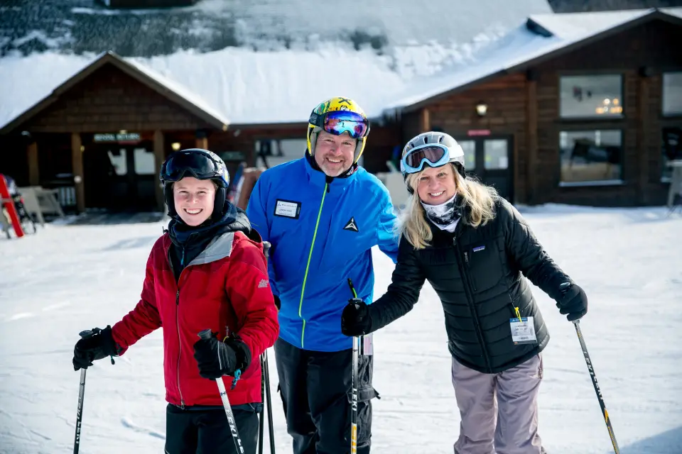 A ski instructor and two people taking ski lessons at Bear Den Mountain.
