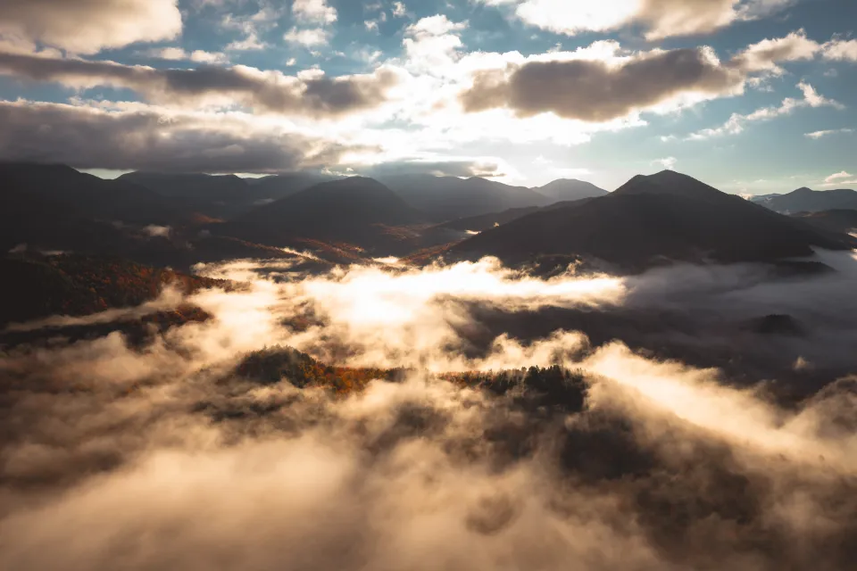 Misty mountains in the fall, seen from the sky