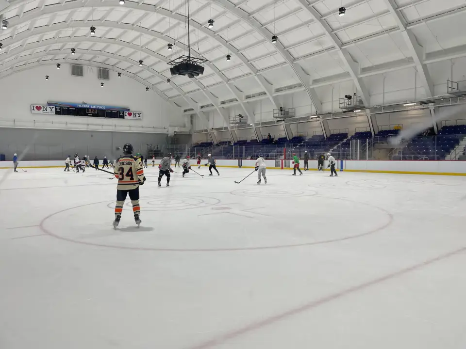 Hockey teams compete in a pickup game at an indoor rink.