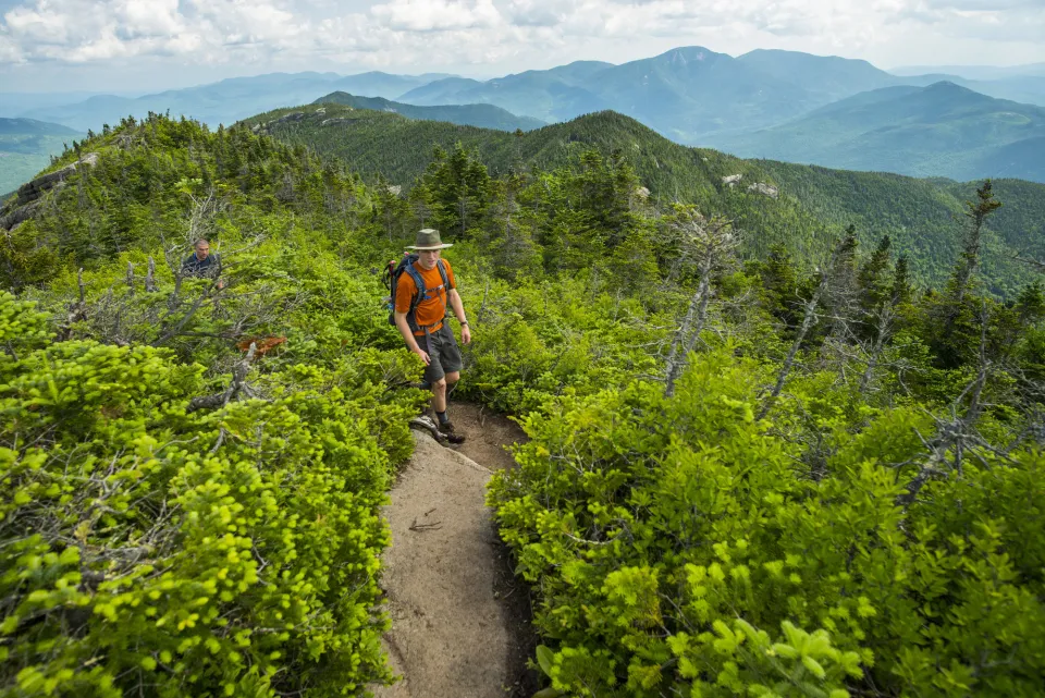 A hiker on a high mountain in the Adk