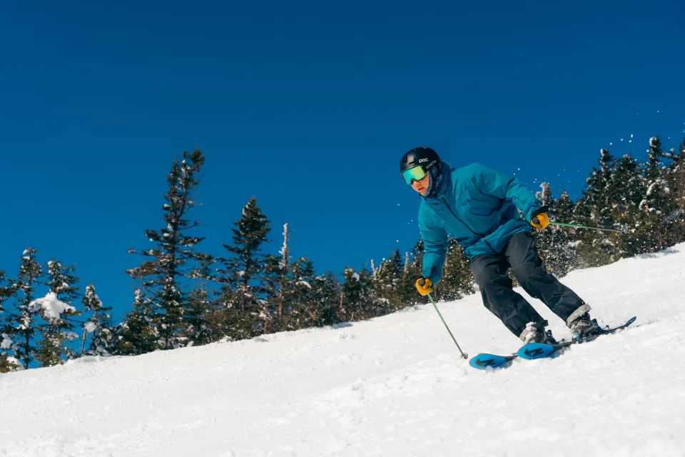 A skier races down a powdery mountain. 
