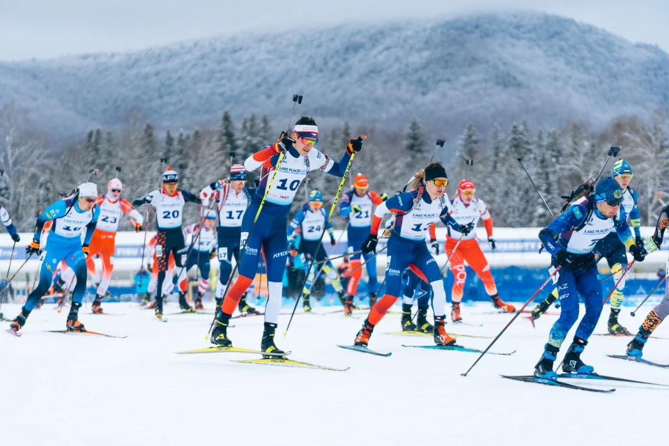 A group of professional skiers in the snow prepping for an event.