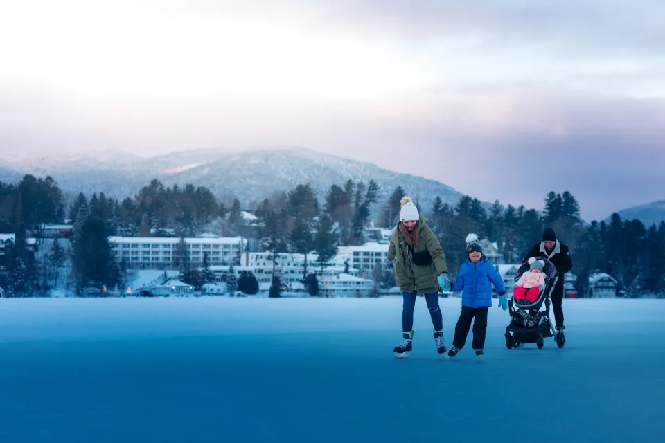 A family ice skates on an icy lake.