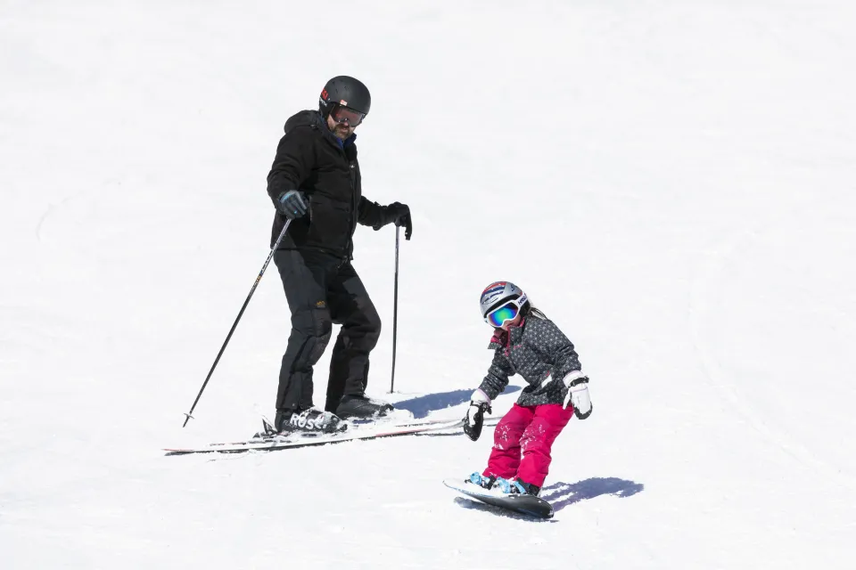A dad and daughter skiing at Whiteface Mountain.
