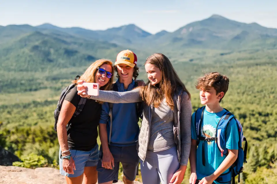 A family posing for a selfie at Mt Van Hoevenberg.
