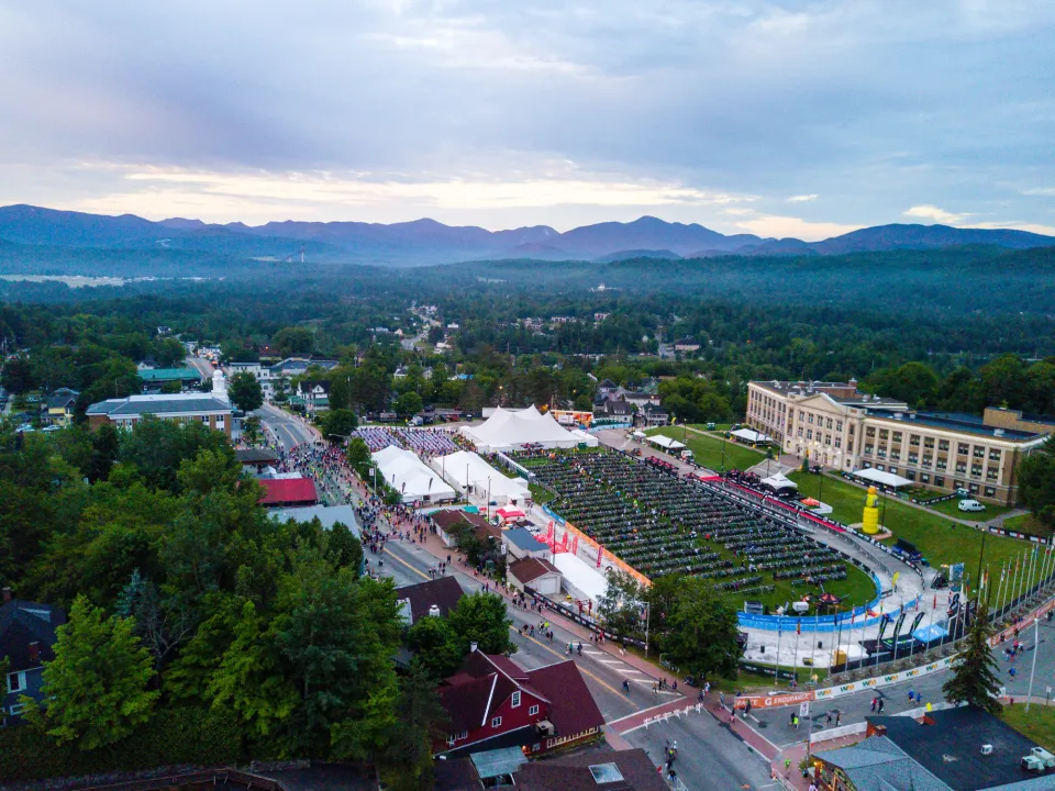 An overhead view of the Ironman race on a large field in the center of town. 